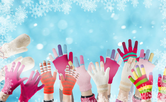 children gloves and winter snow background with snowflakes