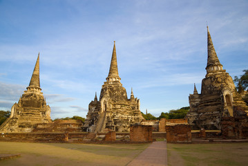 Fototapeta na wymiar Three stupas of the ancient Buddhist temple of Wat Phra Si Sanphet at dawn. Ayutthaya. Thailand