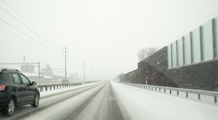 dangerous winter road conditions on a highway with oncoming traffic