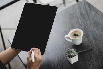 Mock up of a woman holding digital tablet device in hands with digital pencil. Tablet and digital pen connecting wifi. Copy space. - Image