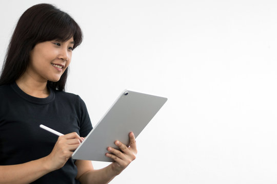 Woman holding new version digital tablet device in hands with smart pencil. Tablet and digital pen connecting wifi. Copy space. - Image.