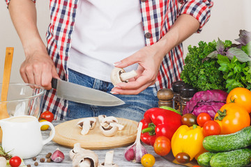 Woman cooks at the kitchen, body part, blurred background