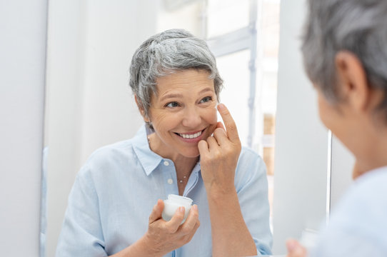 Senior woman applying anti aging cream