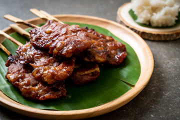 grilled skewered milk pork with white sticky rice