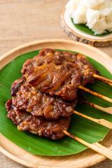 grilled skewered milk pork with white sticky rice