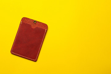 Red leather card holder mock up on yellow background. Sleeve cardholder pocket. Flat lay background. Business concept.