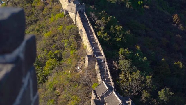 a section of the Chinese Great wall that rises up the side of the mountain in a begining of fall