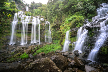 Beautiful large waterfall in the forest. Landscape of rainforest abundant natural resources in Thailand.