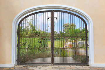 Iron gate on cement wall to the garden.