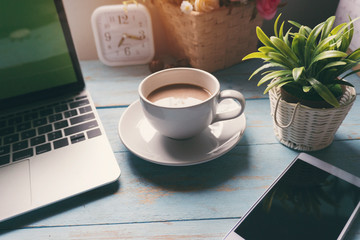 Top view of Working space at home.Office businees desk with Cup of Coffee,Desktop laptop,Calendar 2019,smart phone,clock and pot of tree on blue wooden desk.Urban Lifestyle concept