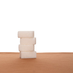 Stack of four sugar cubes on fabric, white background. Healthy eating.
