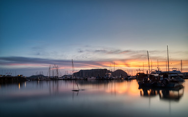 Boat docked in Harbour during sunset