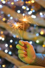 Hand holding sparklers