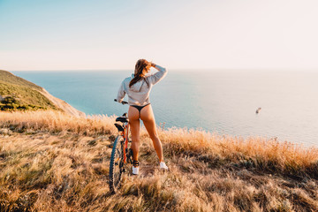 Sporty woman with red mountain bicycle in outdoor