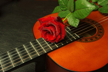Classical Spanish guitar and red rose