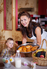 Mother and son in the kitchen with pastries.