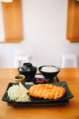 Tonkatsu fried pork cutlet with rice and soup on wooden table Japanese food