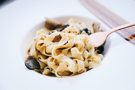 pasta with black truffles on wood background , Italian food