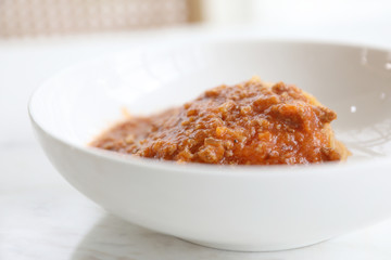spaghetti Bolognese with minced beef and tomato sauce garnished with parmesan cheese and basil , Italian food