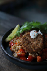 salmon fishcakes with oat and salad on wooden table