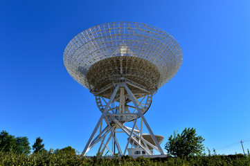 Array of satellite dishes or radio antennas against sky. Space o