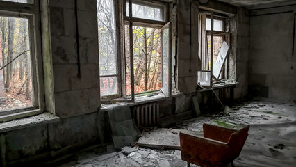 Fototapeta na wymiar old chair inside an abandoned building in Chernobyl Ukraine