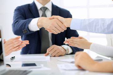 Group of business people or lawyers shaking hands finishing up a meeting , close-up. Success at negotiation and handshake concepts