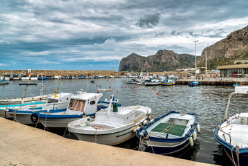 Fototapeta na wymiar Fishing boats in the small harbor of Isola delle Femmine or Island of Women, province of Palermo, Sicily, Italy