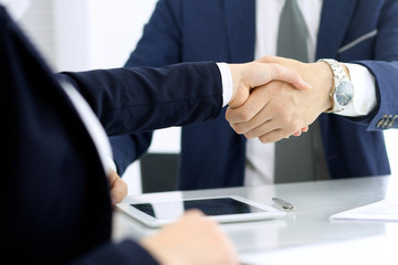 Group of business people or lawyers shaking hands finishing up a meeting , close-up. Success at negotiation and handshake concepts