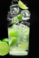 Brazilian caipirinha splash in black background
