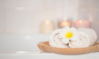 Spa still life setting with frangipani flower and towels