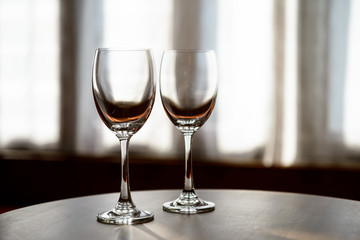 Empty Wine glasses with blur curtain background