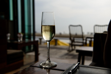 champagne glass with blurred sea and sky background