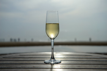 champagne glass with blurred sea and sky background