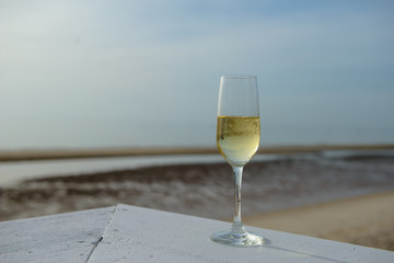 champagne glass with blurred sea and sky background