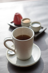 Hot tea served in a mug with milk and sugar