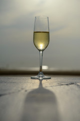 champagne glass with blurred sea and sky background