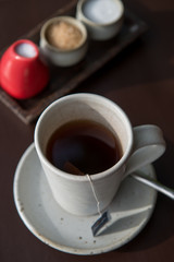 Hot tea served in a mug with milk and sugar