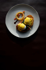Poached egg with hollandaise sauce on toast with salmon ham and spinach