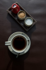 Hot tea served in a mug with milk and sugar