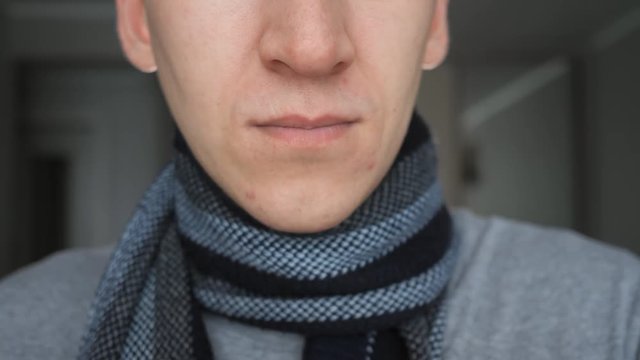 Man with flu and runny nose wipe his nose with a tissue