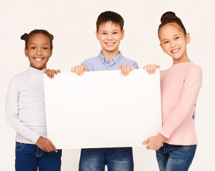 Kids showing blank placard board for text