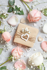 Gift box with roses and small white flowers