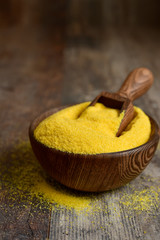 Dried polenta in a wooden bowl.