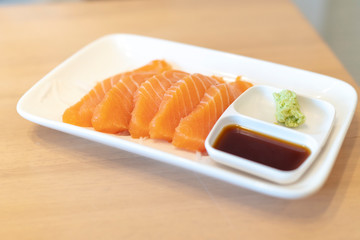 Salmon Slides with Wasabi in a Japanese Restaurant