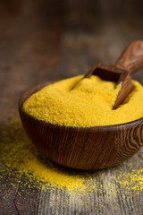Dried polenta in a wooden bowl.