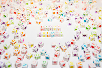 Conceptual of Motivational Happy Sunday Words made with Colorful Alphabetical Beads