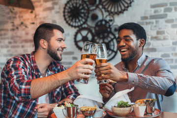 Old friends meeting in bar and drinking beer