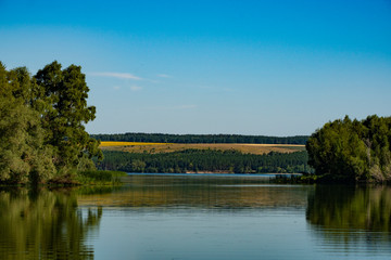 Fototapeta na wymiar pond, river, water, reflection, forest, trees, thickets, hills, blue, sky, space, nature, landscape