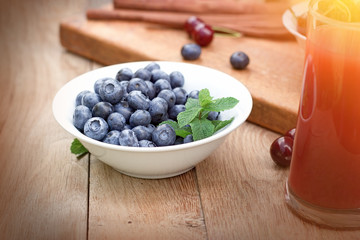 Blueberry - blue berries in bowl on rustic table, healthy organic food